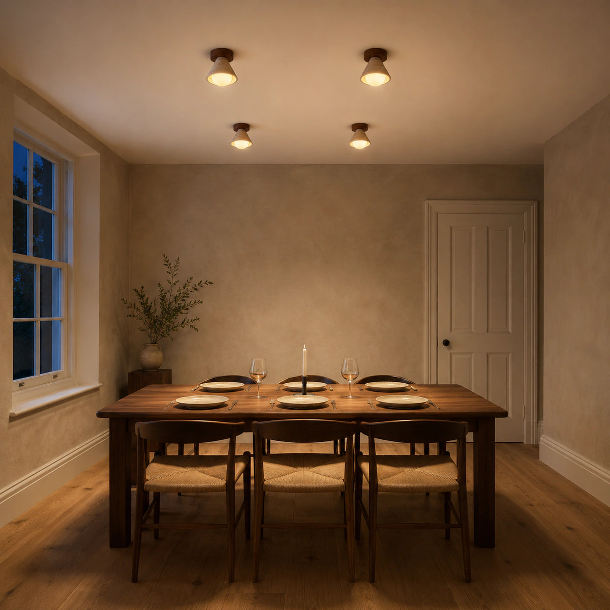 Travertine cone ceiling light above a minimalist dining table