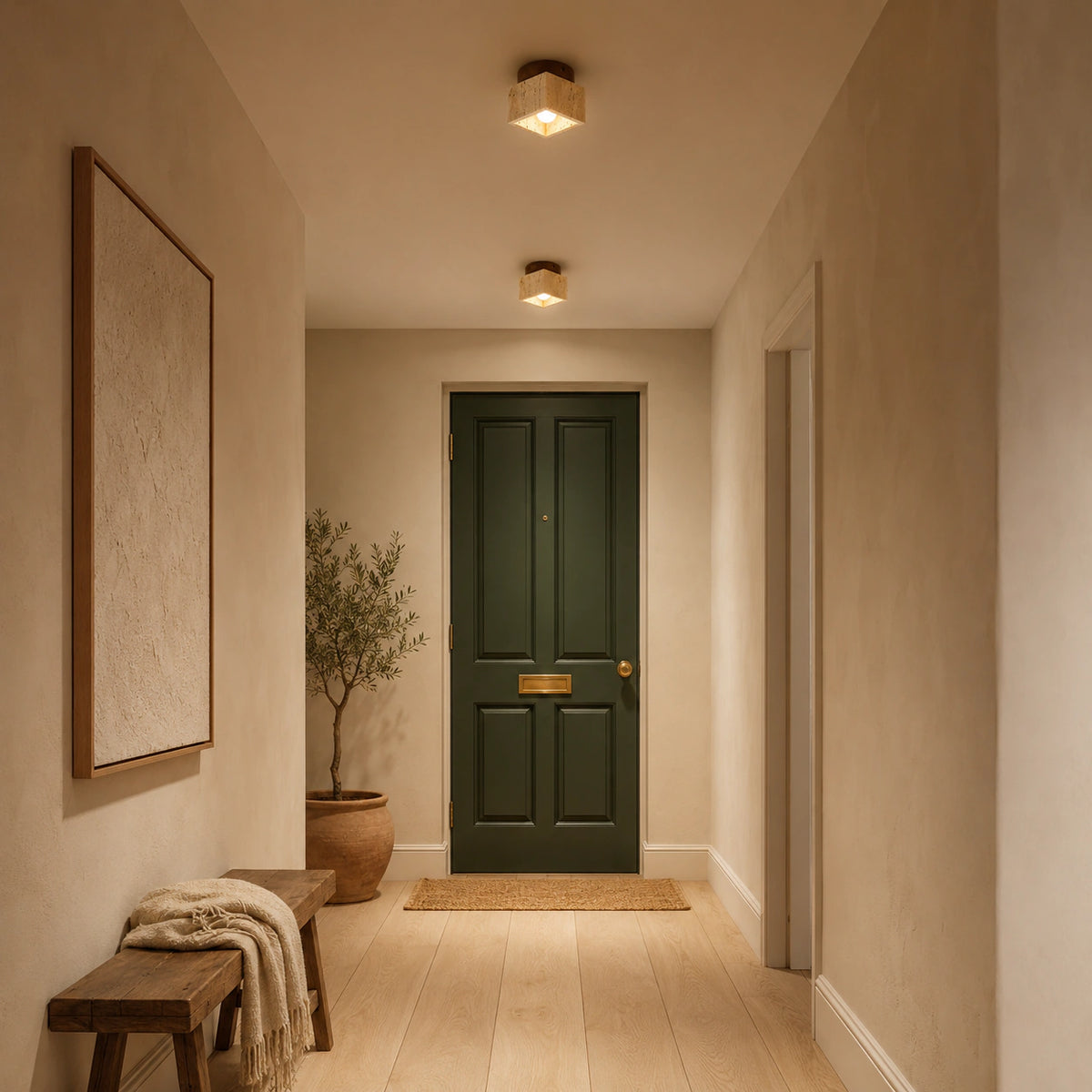 Travertine cube ceiling light lighting the end of a plastered hallway