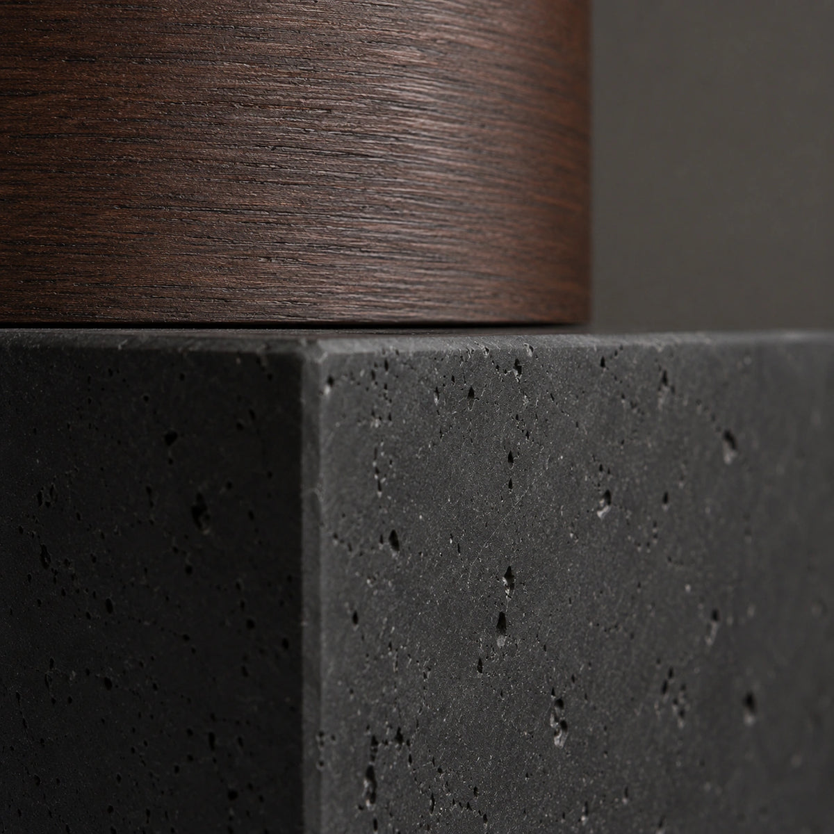 Close-up of the deep pitting in the black travertine cube ceiling light