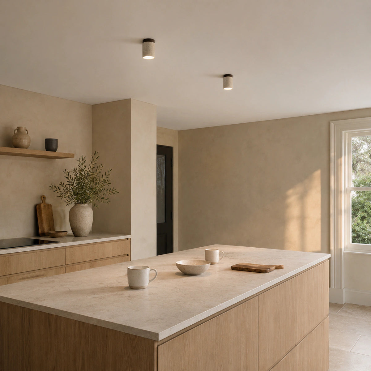 Travertine cylinder ceiling light with a walnut collar in a warm oak kitchen