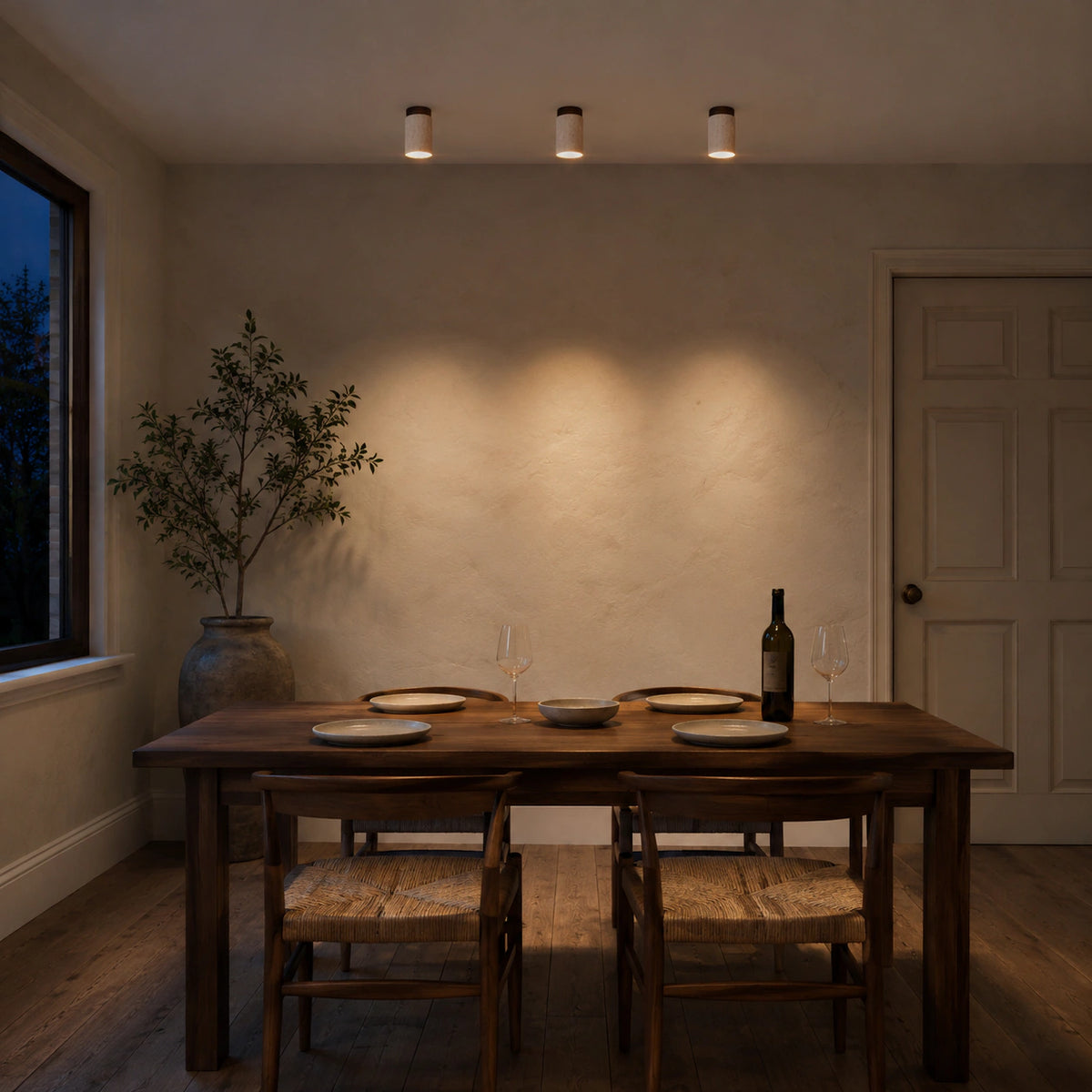 Travertine cylinder ceiling light lighting a minimalist dining room