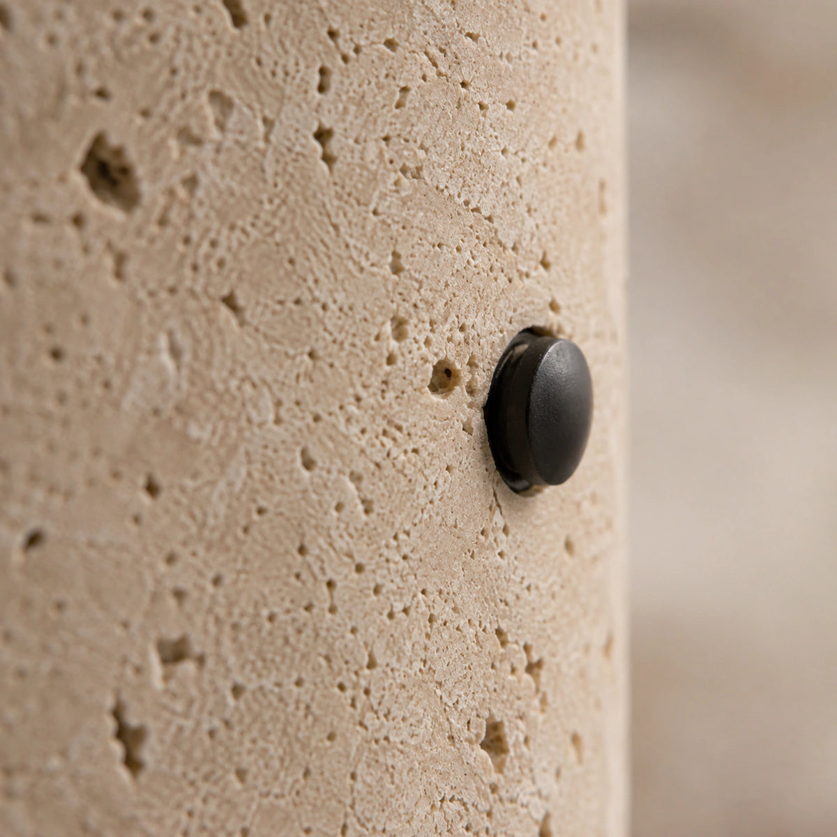 Close-up of the travertine grain on the tube downlight