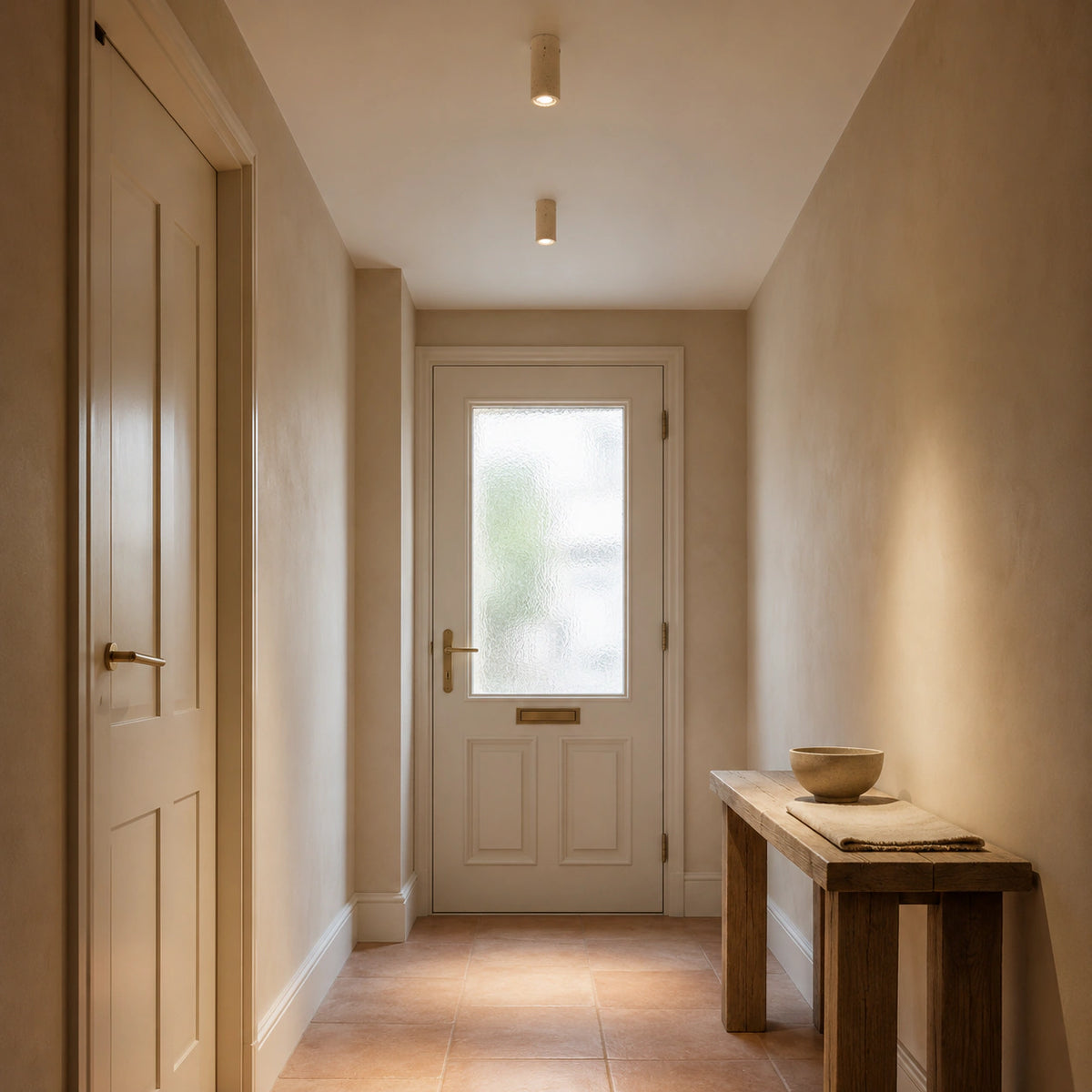 Travertine tube downlight lighting a plastered hallway