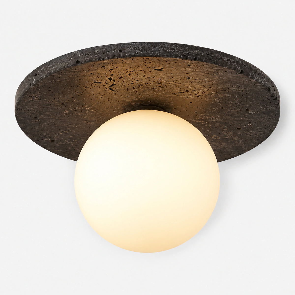Black travertine disc ceiling light with an opal globe on a white background