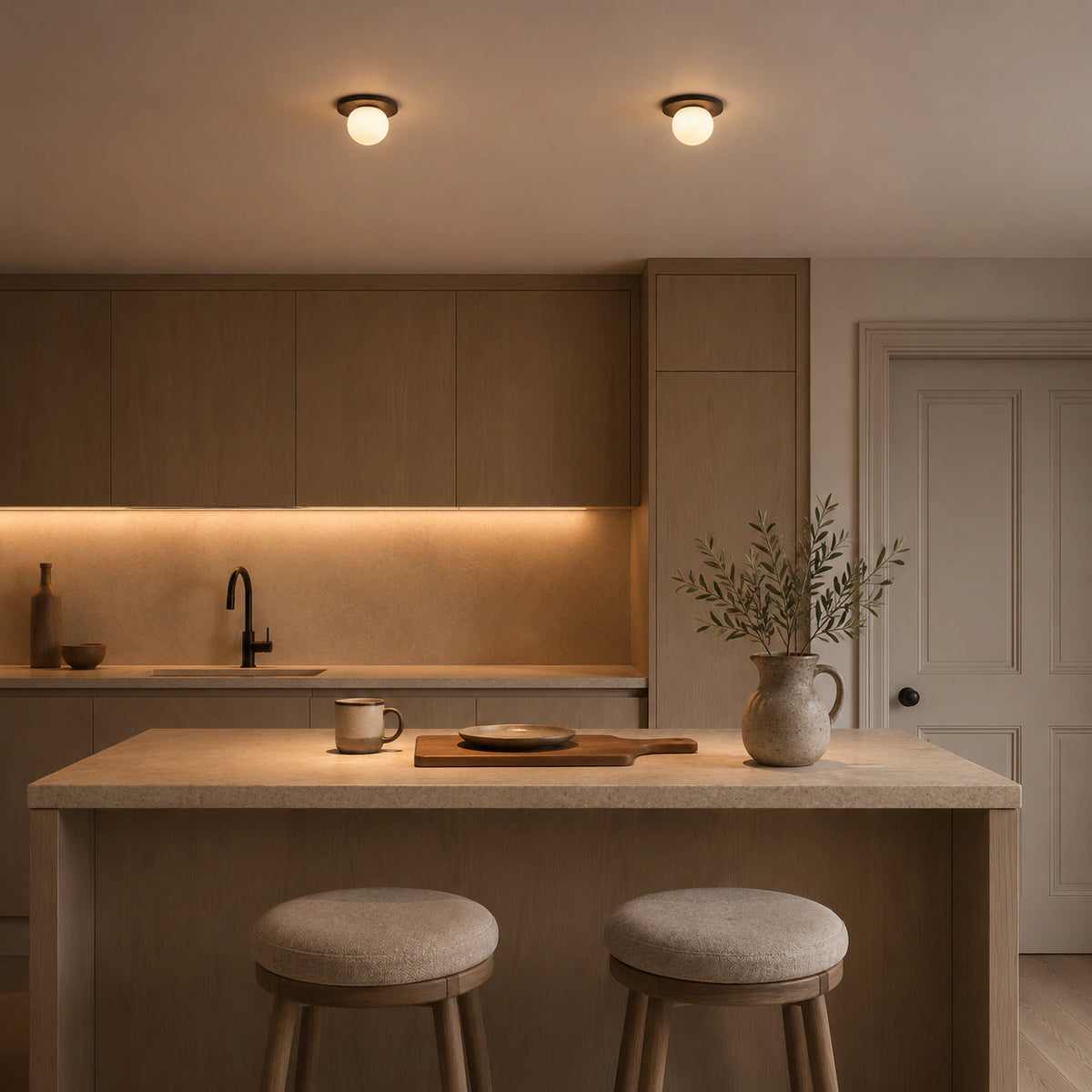 Black travertine disc ceiling light in a warm oak kitchen