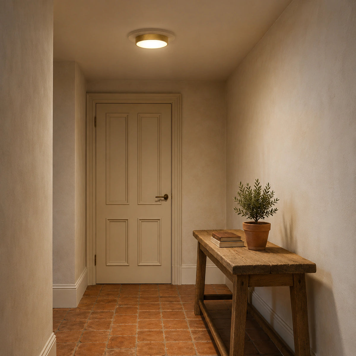 Travertine disc ceiling light lighting a plastered hallway
