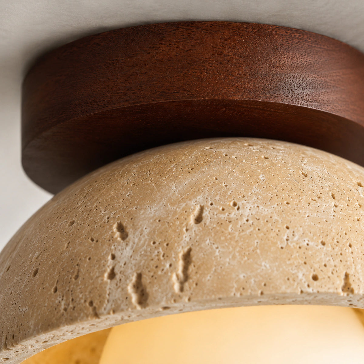 Close-up of the travertine grain on the walnut version of the dome ceiling light