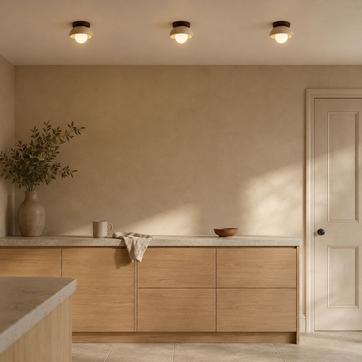 Travertine dome ceiling light with a walnut collar in a warm oak kitchen