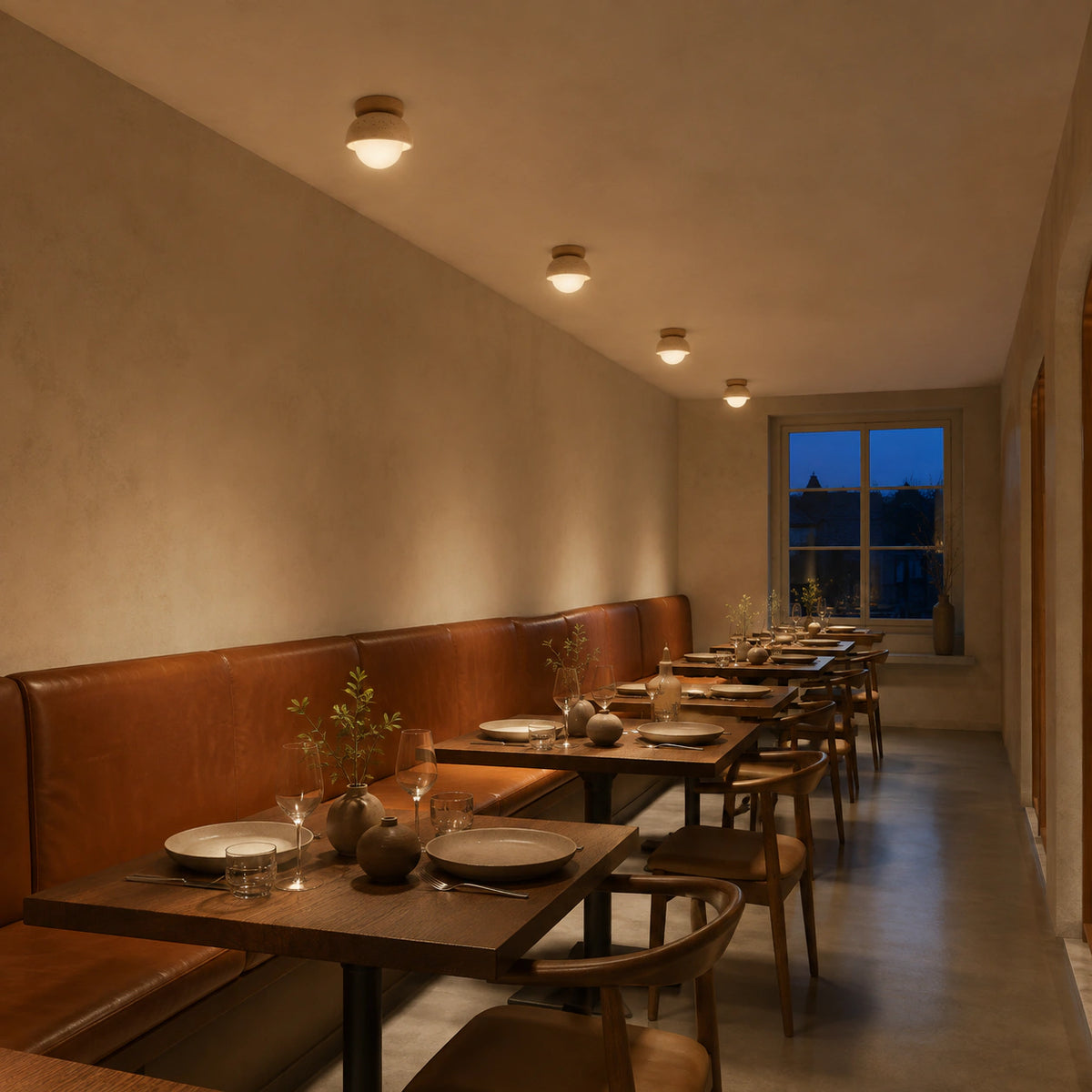 Travertine dome ceiling light above leather banquette seating in a restaurant