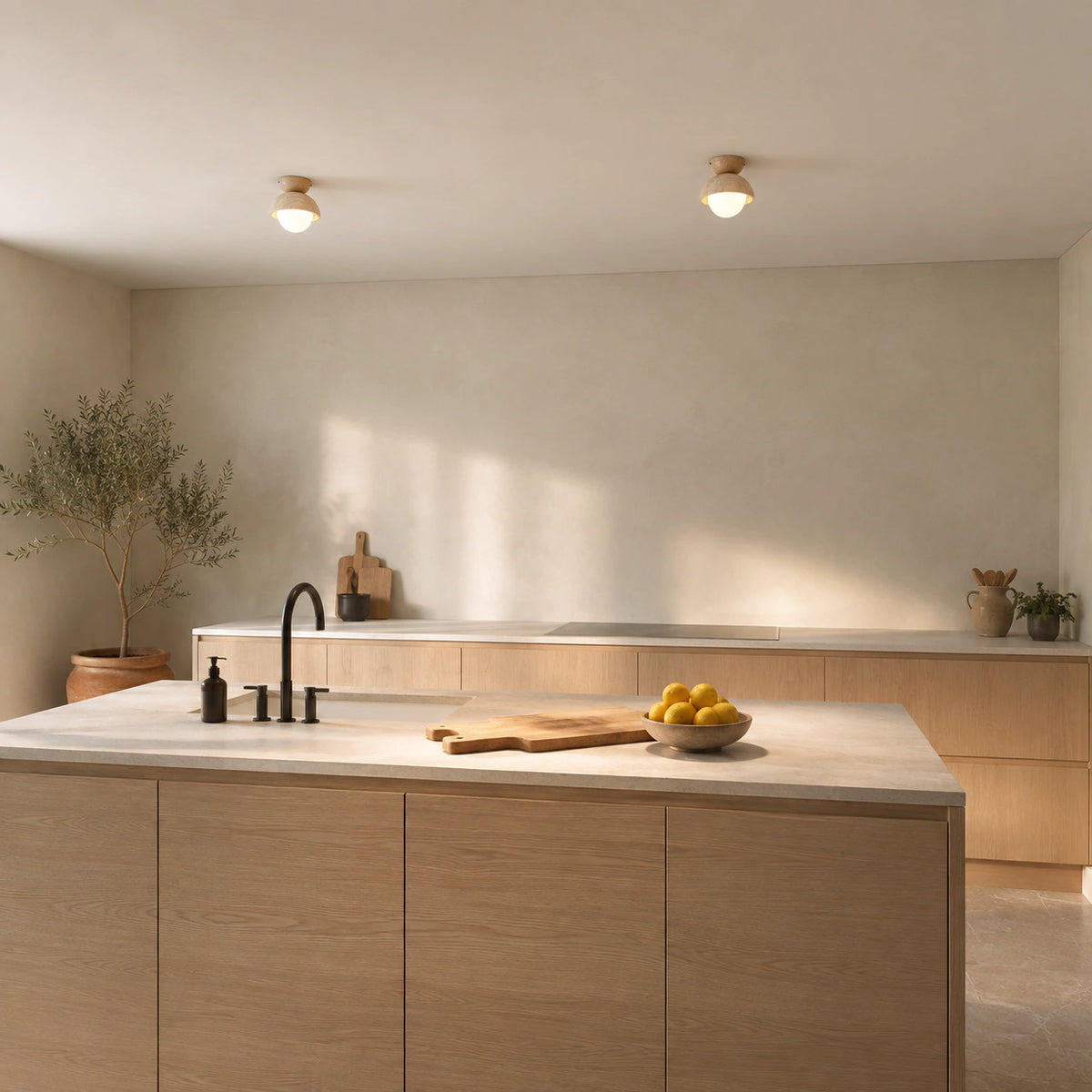 Deep travertine dome ceiling light in a warm oak kitchen