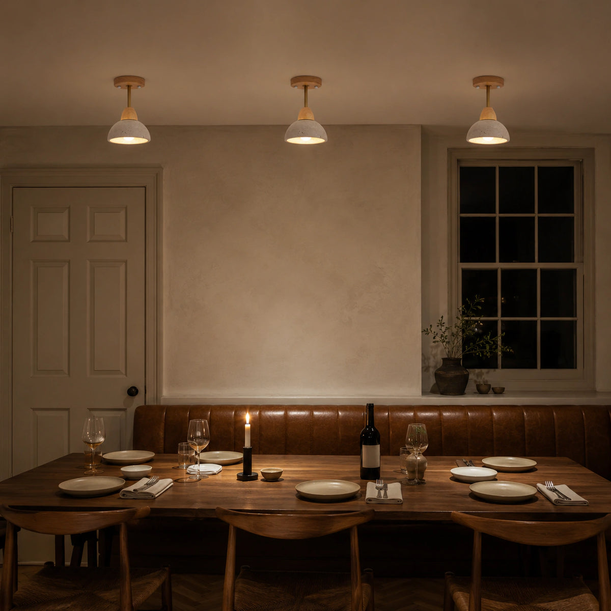 Adjustable travertine dome spotlight above leather banquette seating in a restaurant