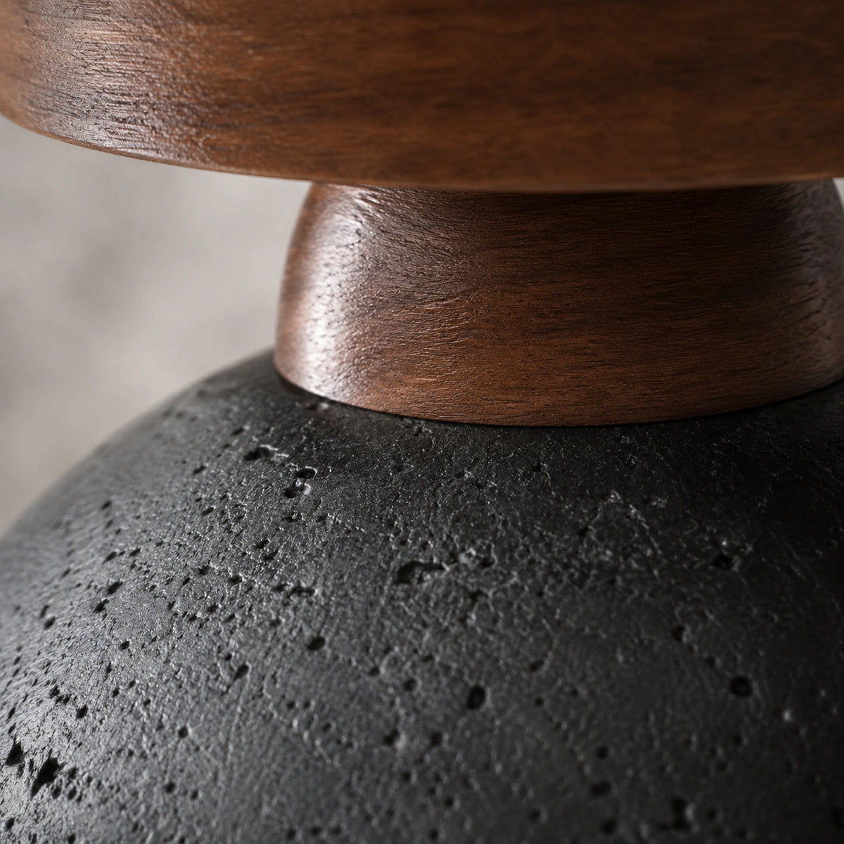 Close-up of the deep pitting in the black travertine dome ceiling light