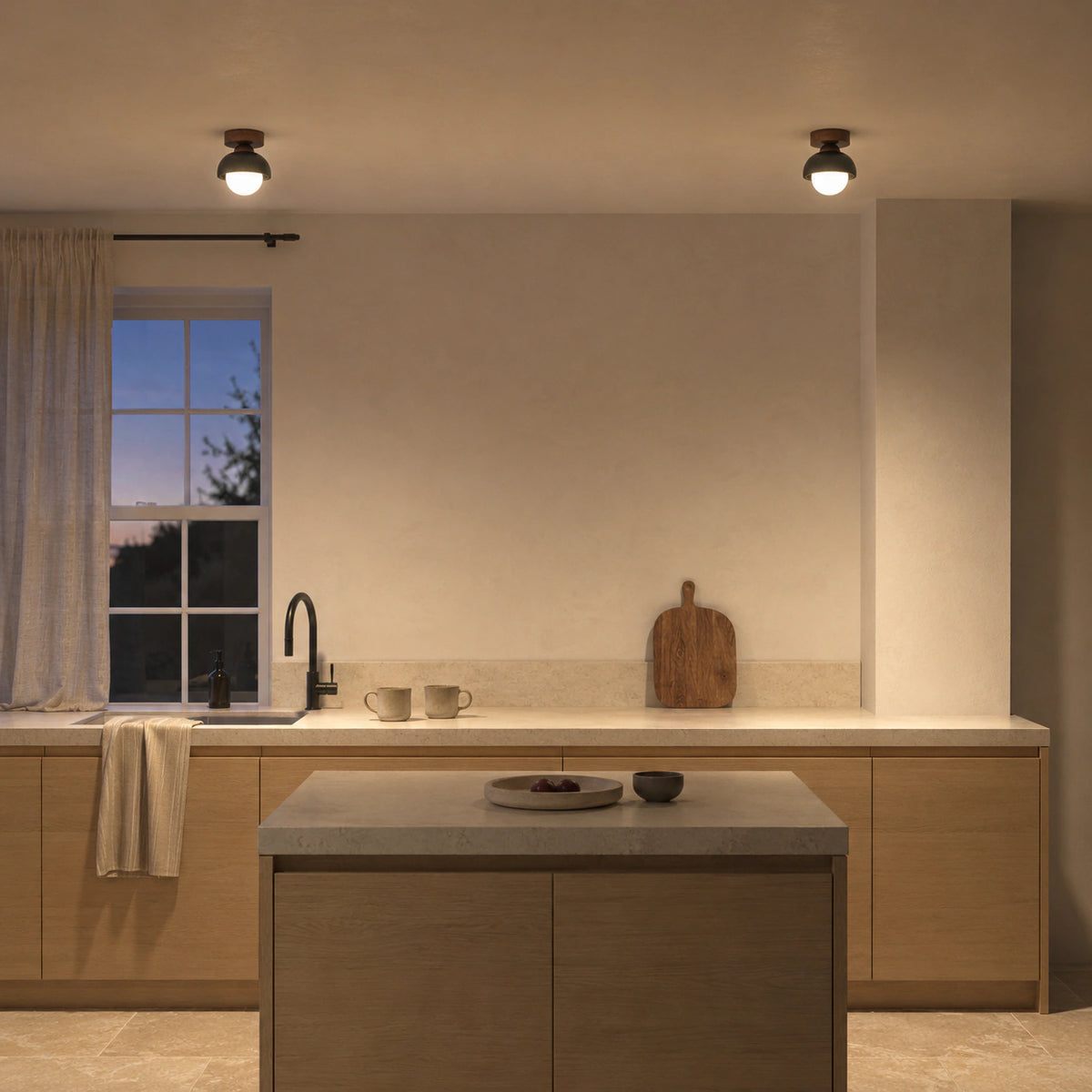 Black travertine dome ceiling light in a warm oak kitchen
