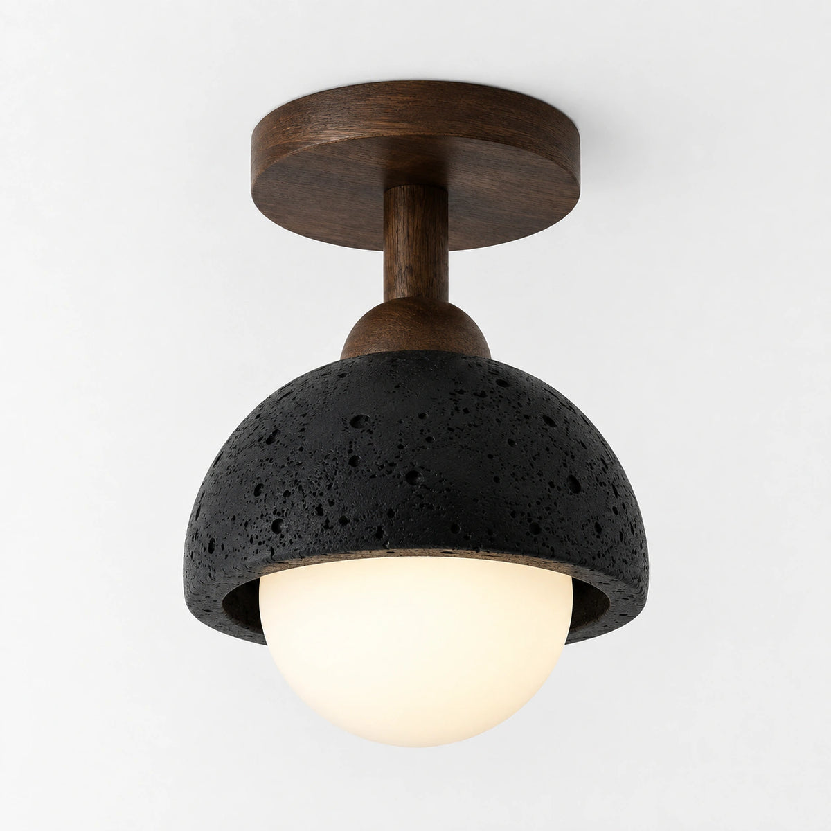 Black travertine dome ceiling light on a walnut semi flush drop, on a white background