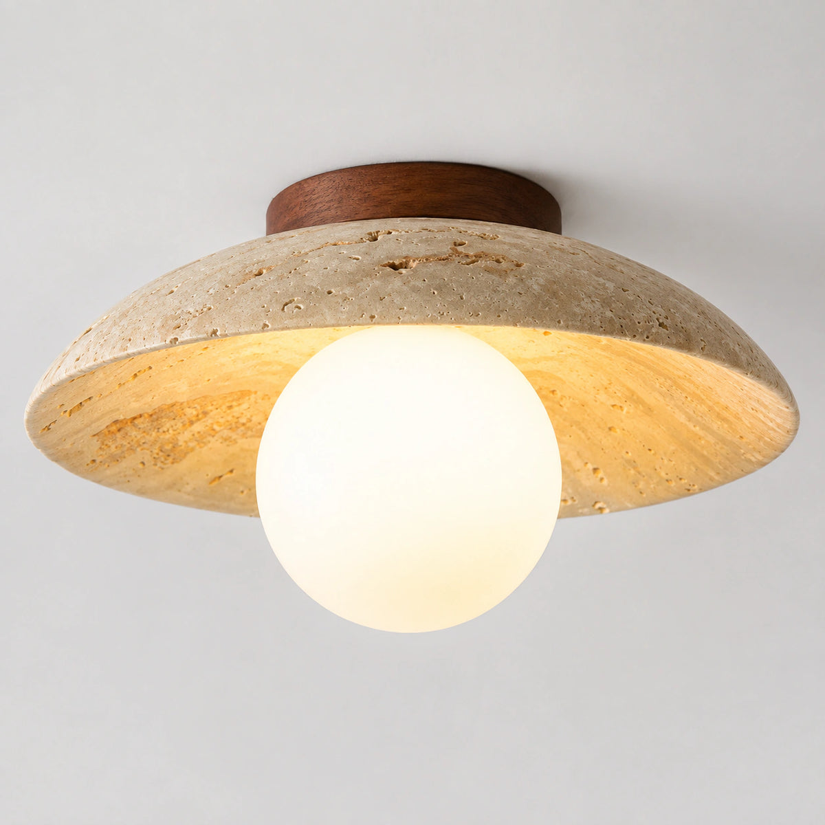 Wide travertine dish ceiling light with an opal globe on a white background