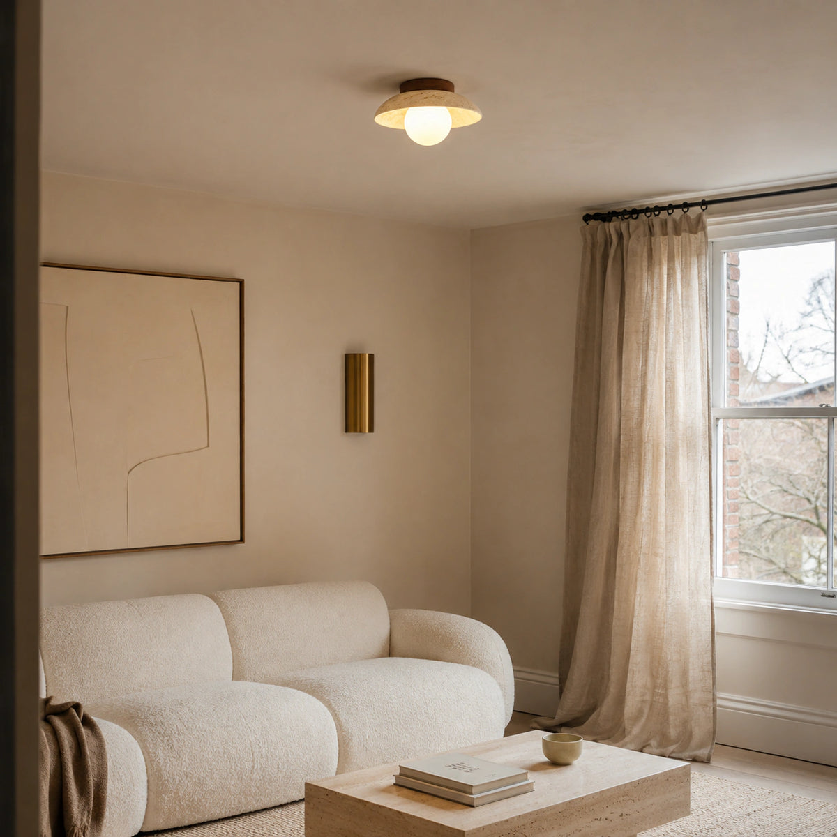 Wide travertine dish ceiling light in a calm neutral living room