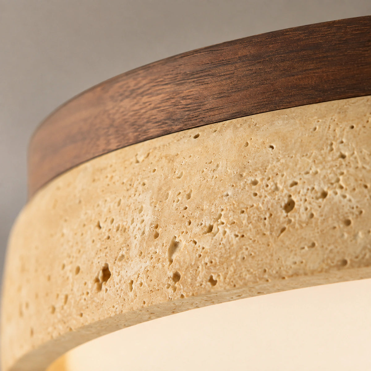 Close-up of the travertine grain on the saucer ceiling light