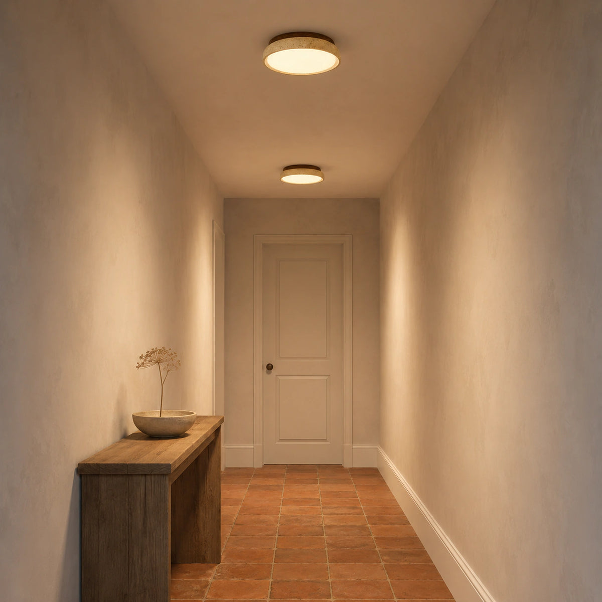 Travertine saucer ceiling light lighting a plastered hallway