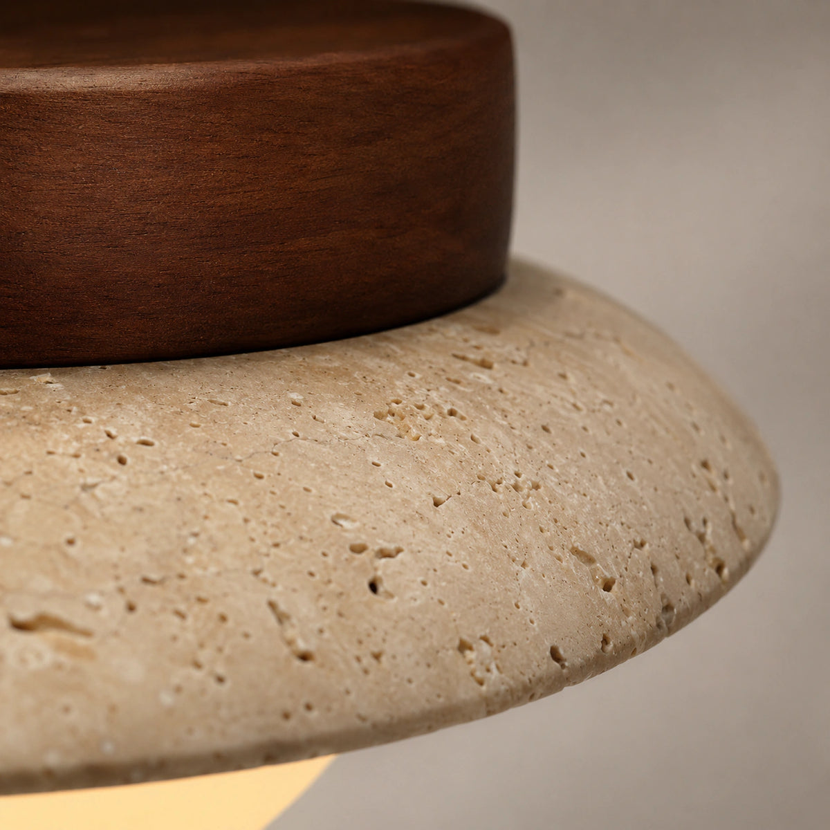 Close-up of the travertine grain on the flat dish ceiling light