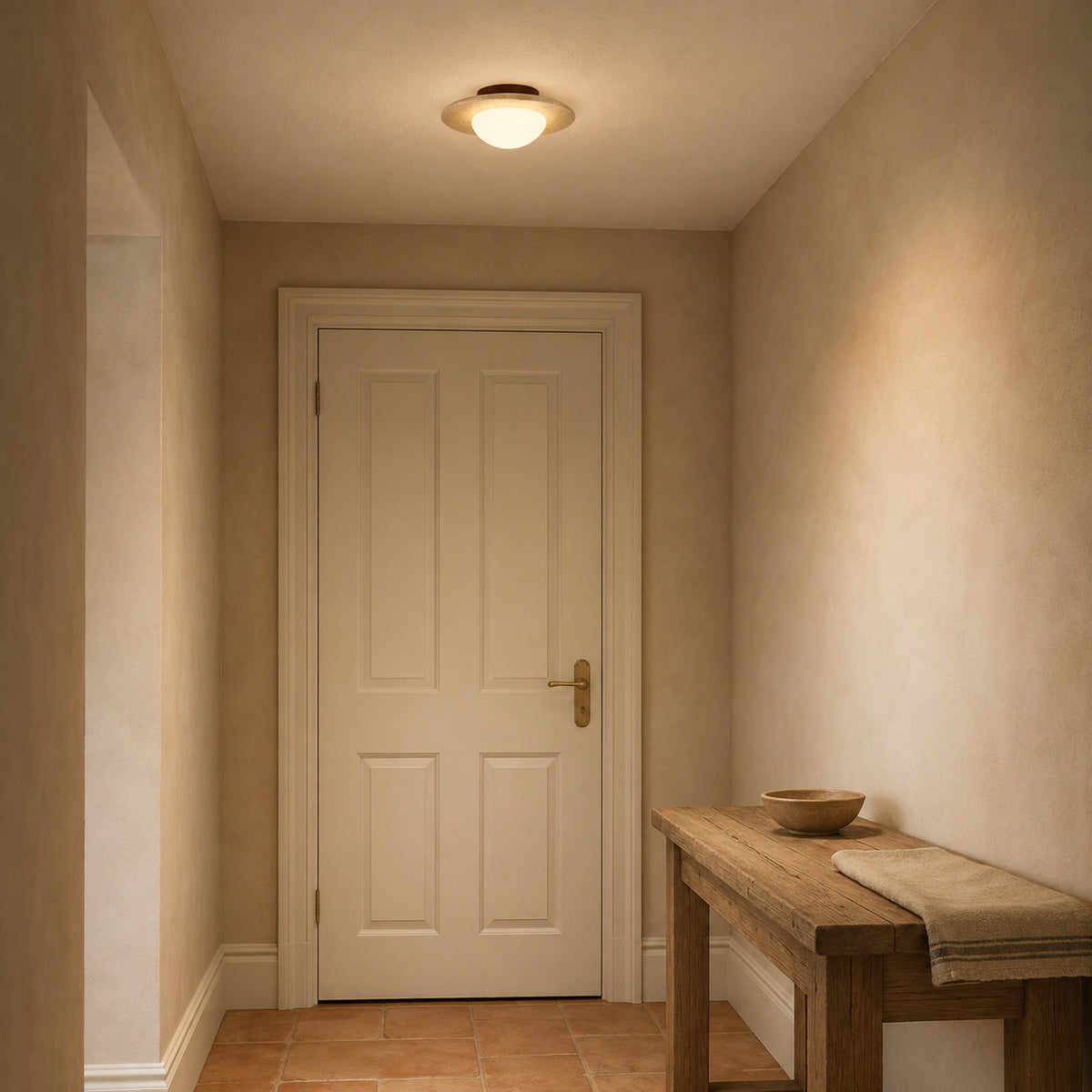 Flat travertine dish ceiling light lighting a plastered hallway