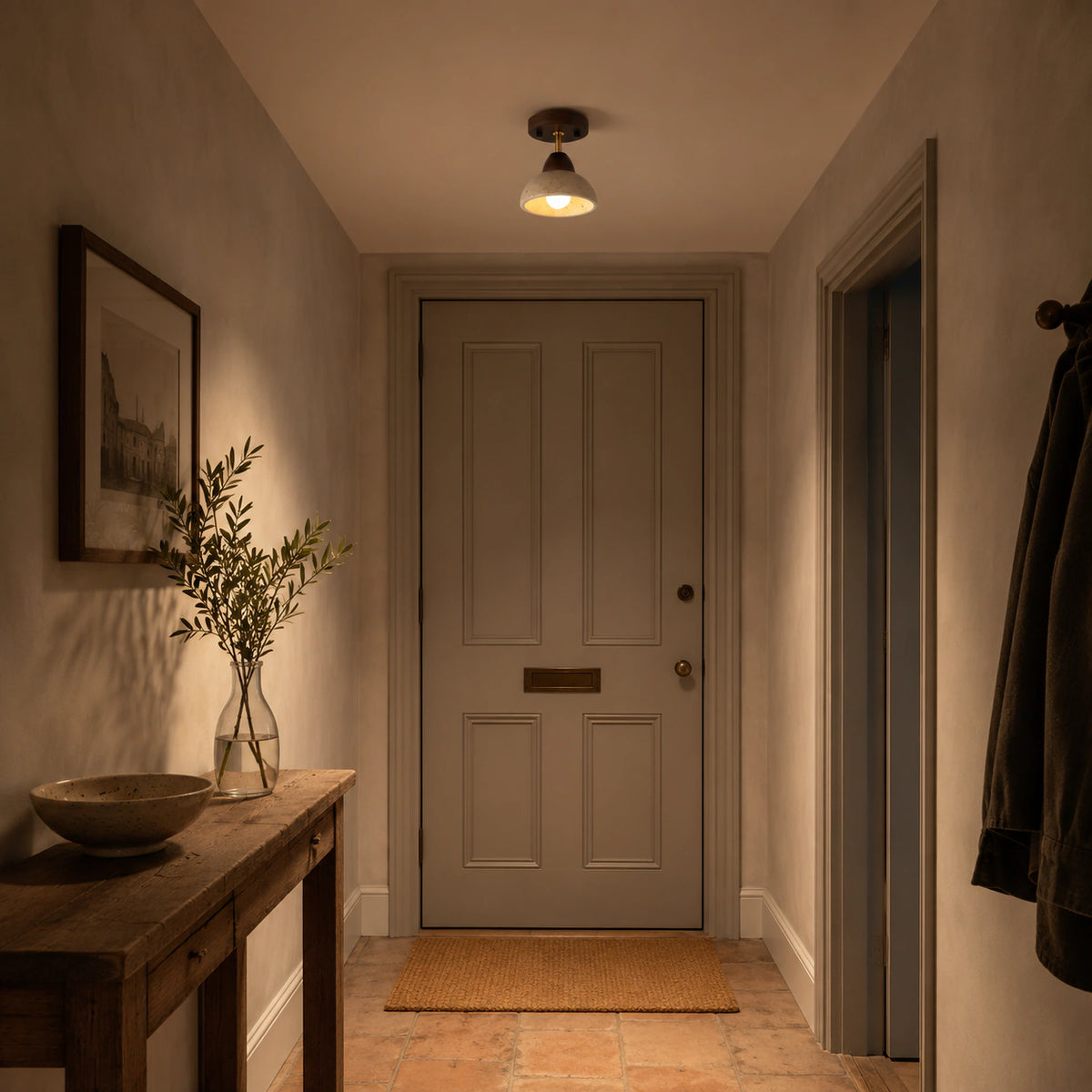 Adjustable travertine dome spotlight lighting a plastered hallway