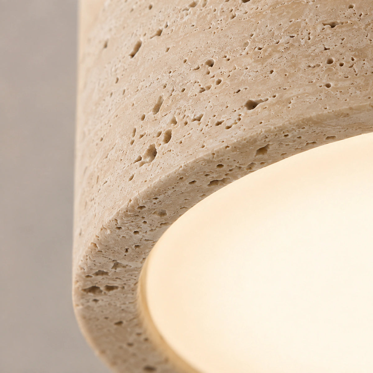 Close-up of the open travertine grain on the all stone flush ceiling light