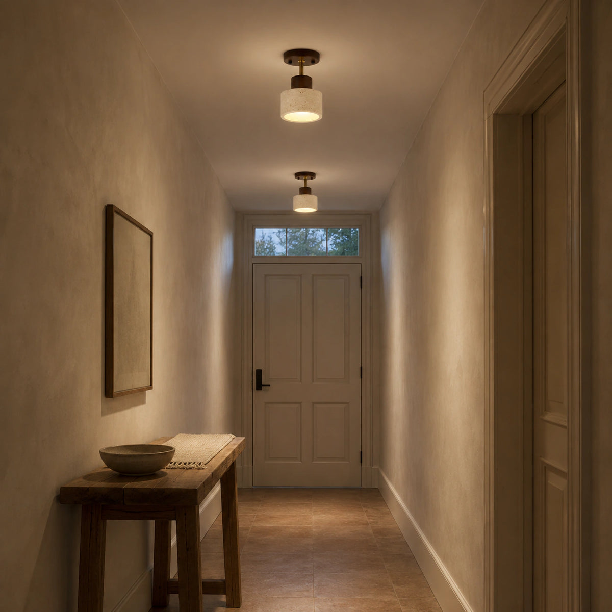 Adjustable travertine drum spotlight lighting a plastered hallway