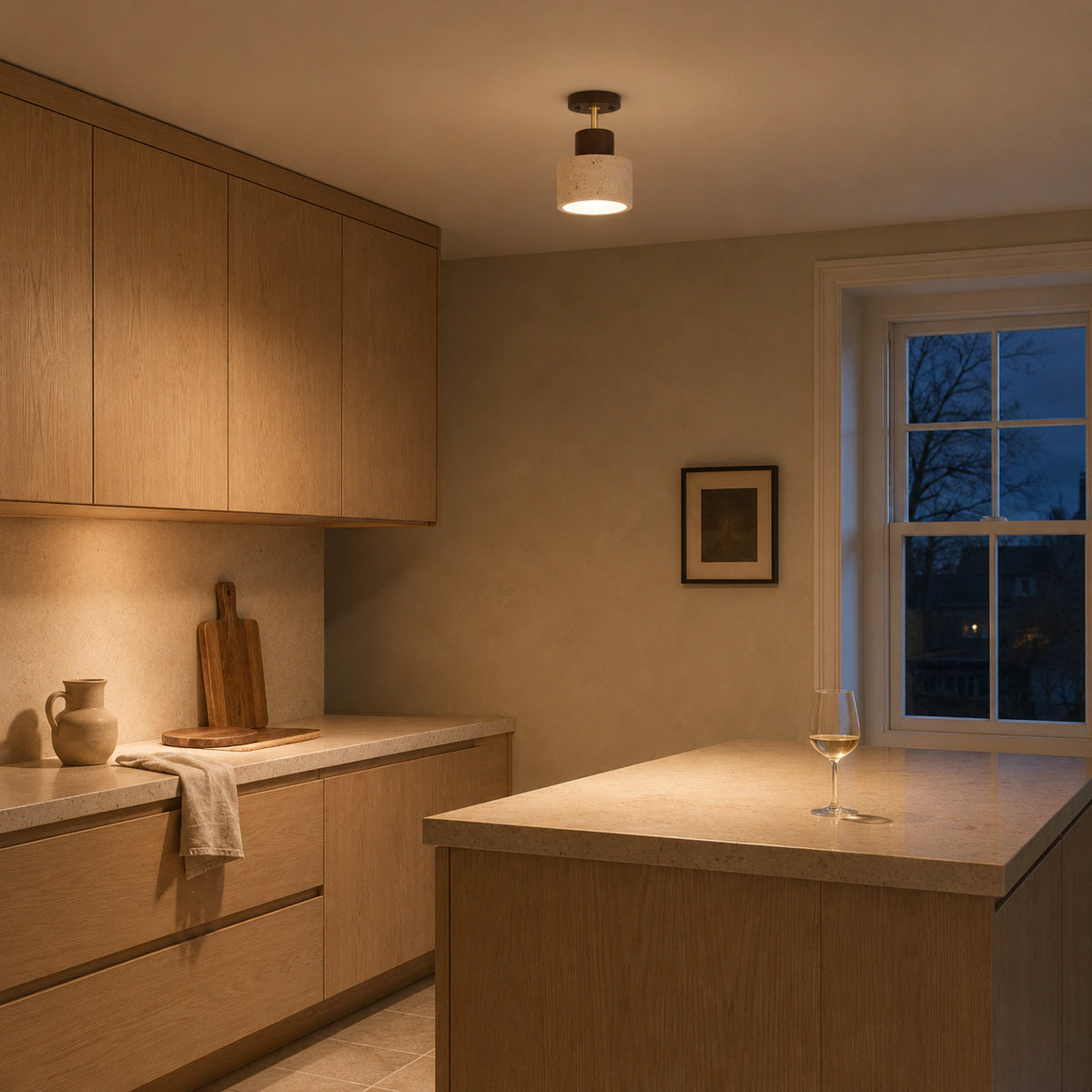 Adjustable travertine drum spotlight in a warm oak kitchen