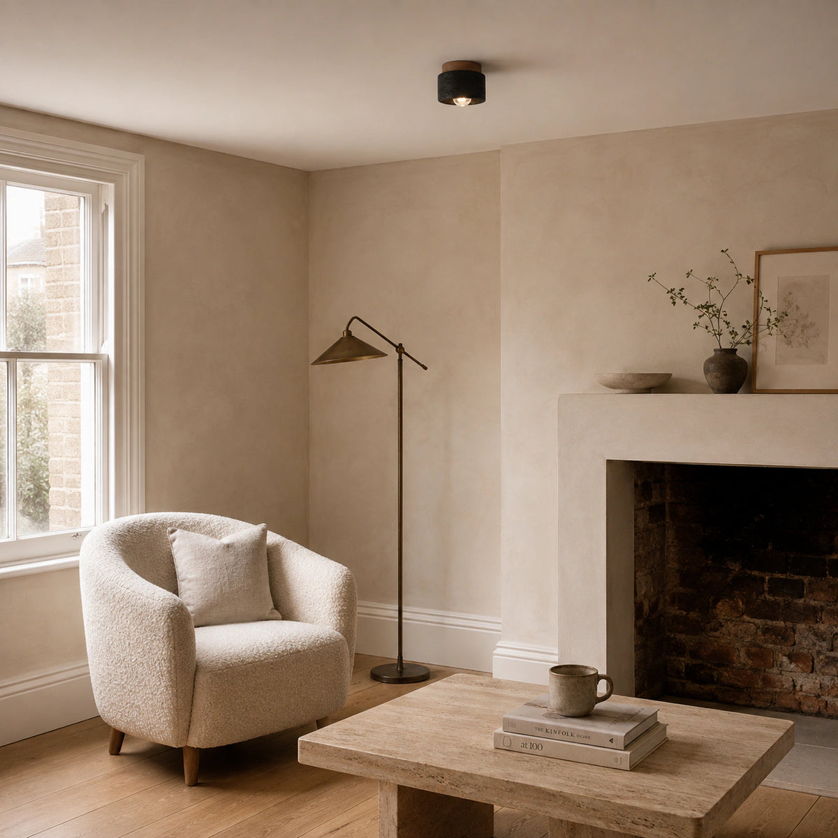 Black travertine drum ceiling light in a calm neutral living room