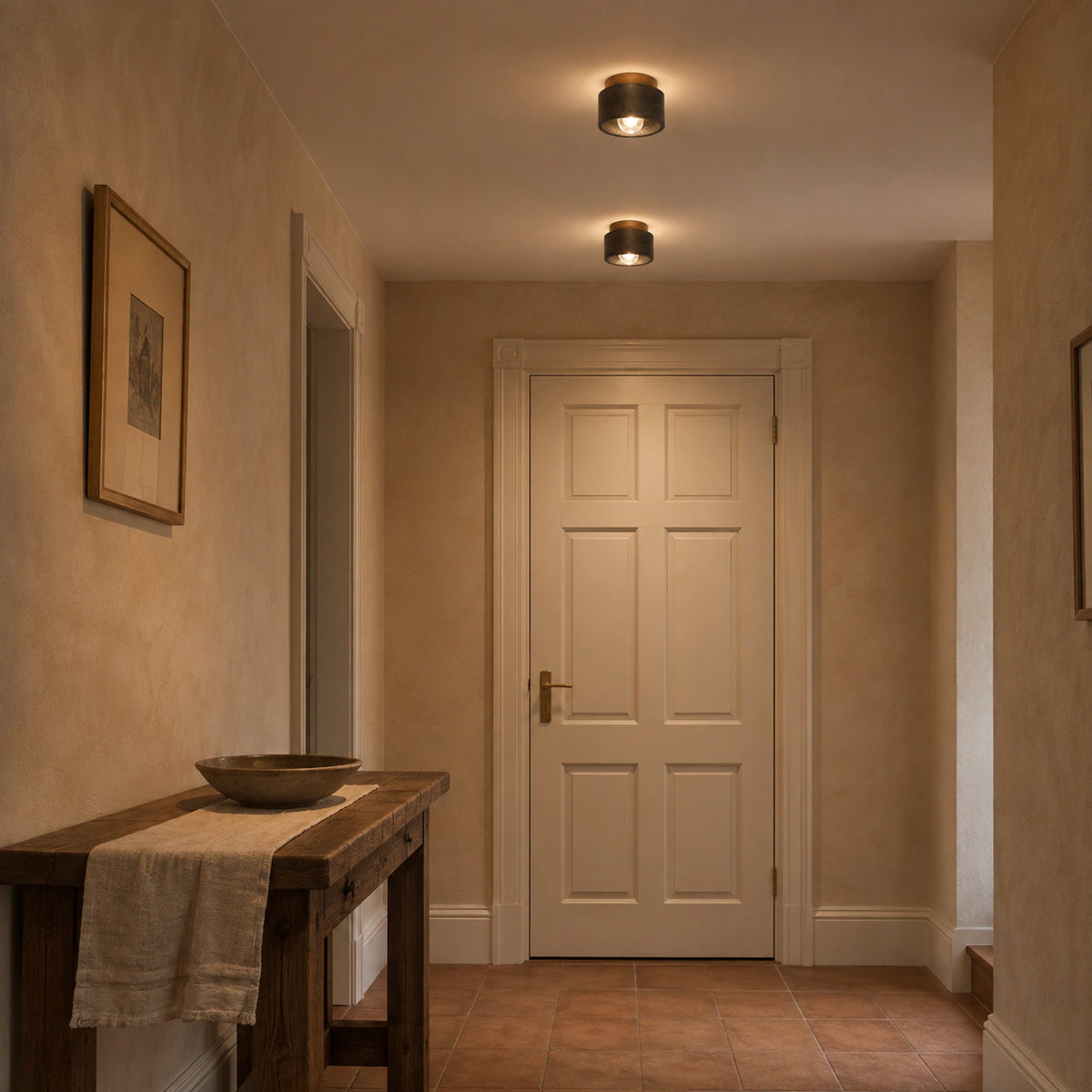 Black travertine drum ceiling light lighting a plastered hallway