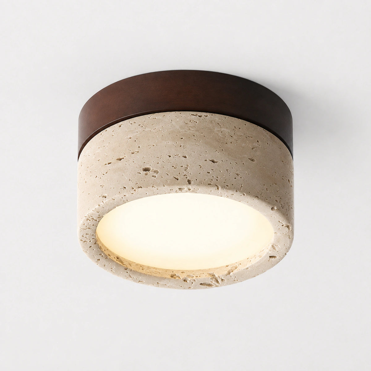 Travertine flush ceiling light with a walnut band on a white background