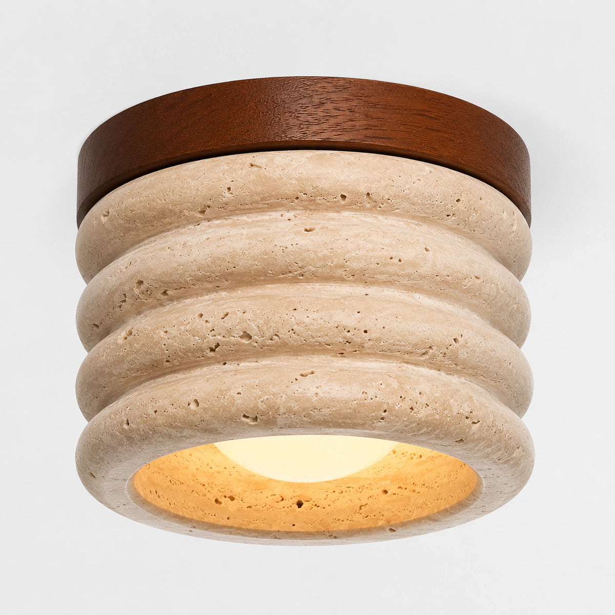Fluted travertine ceiling light with a walnut ring on a white background