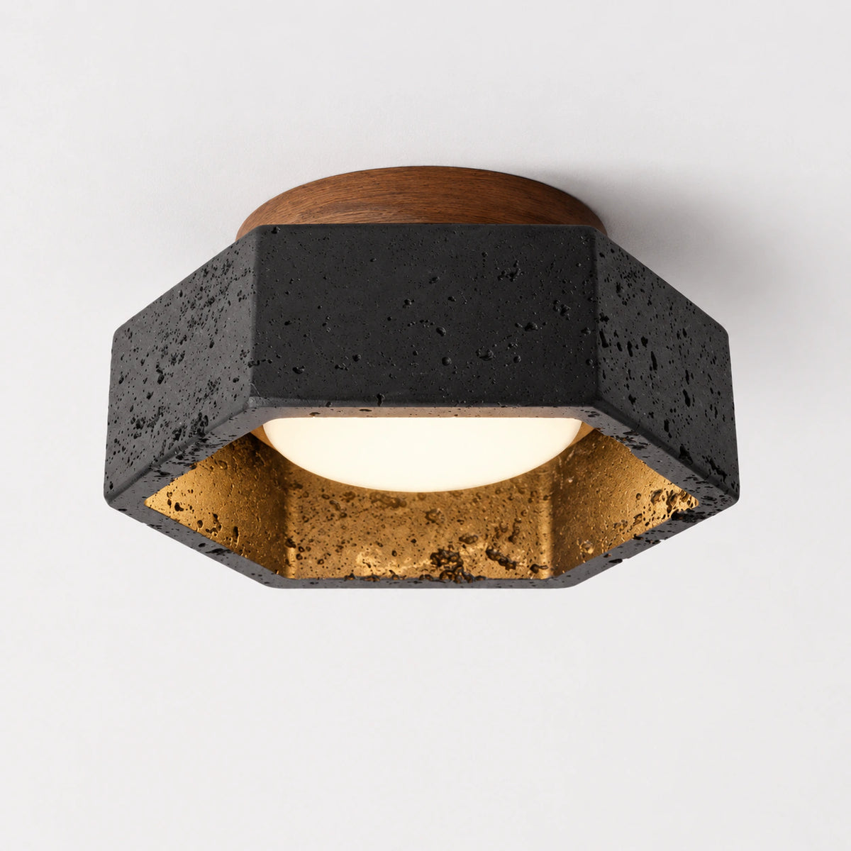 Black travertine hexagonal ceiling light with a walnut collar on a white background