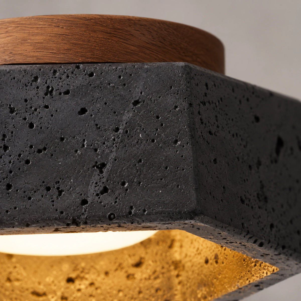 Close-up of the deep pitting in the black travertine hexagonal ceiling light