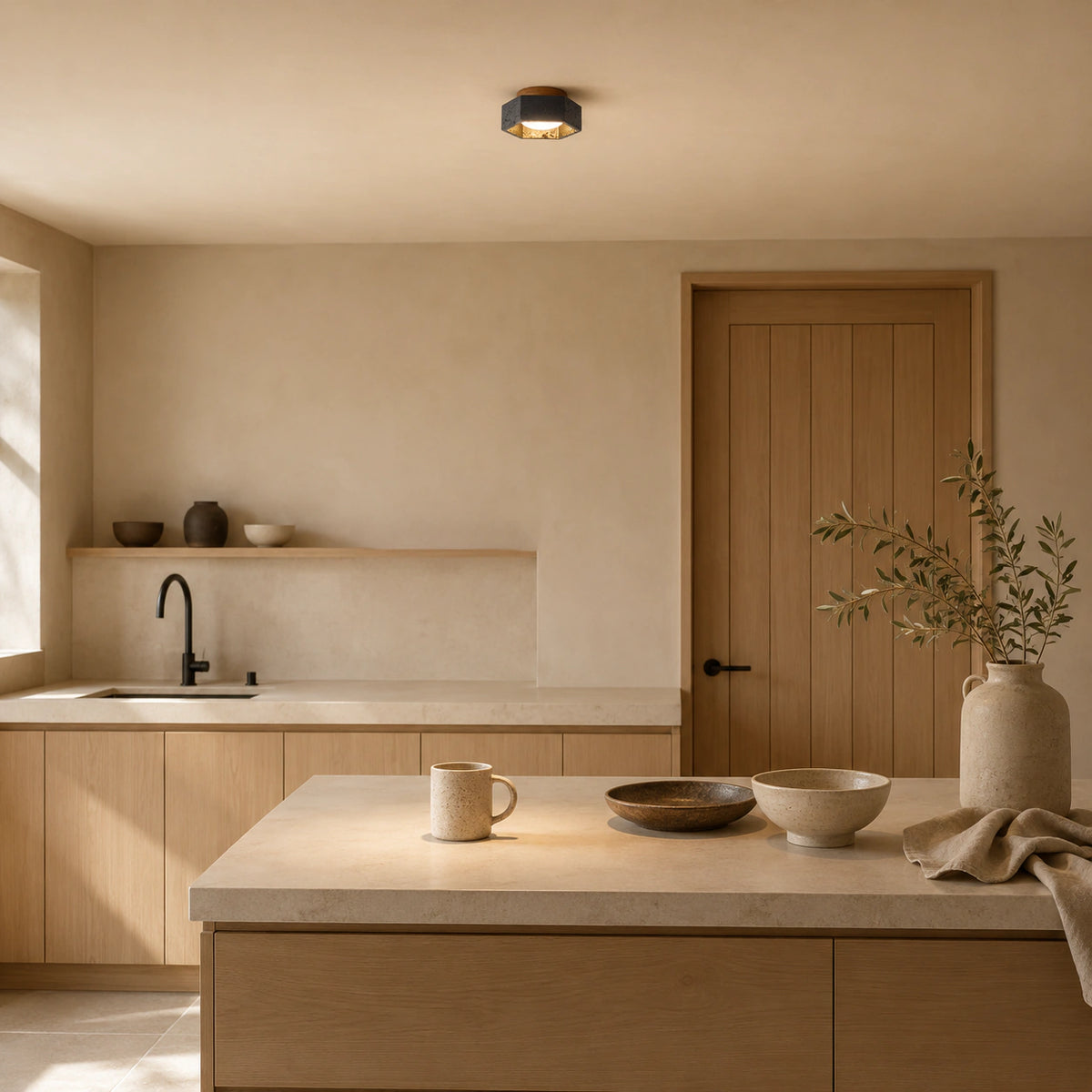 Black travertine hexagonal ceiling light in a warm oak kitchen