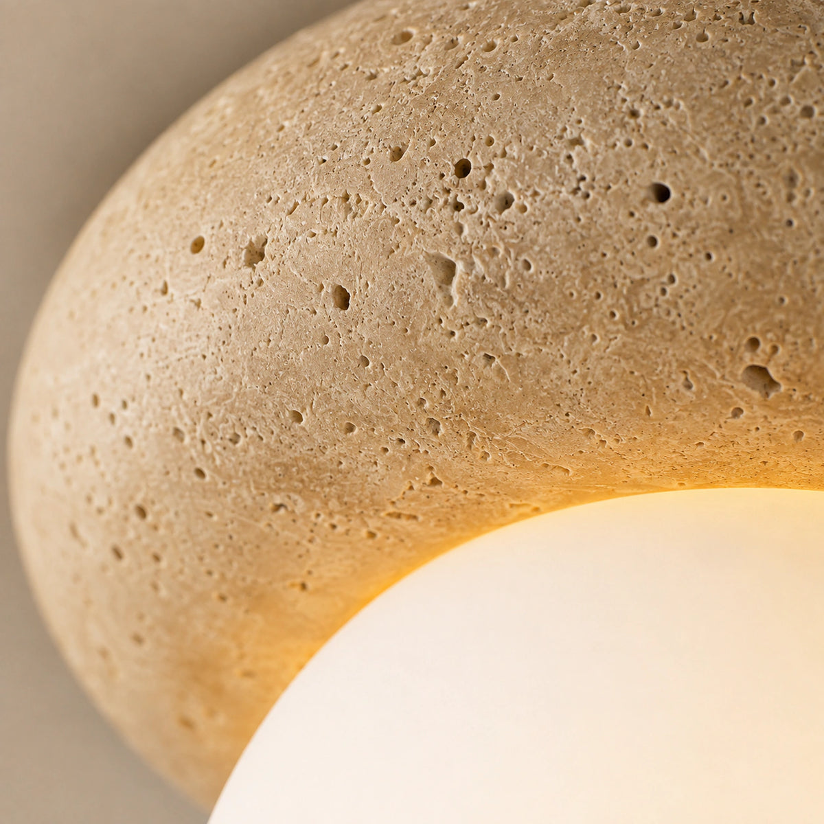 Close-up of the travertine grain on the pebble ceiling light