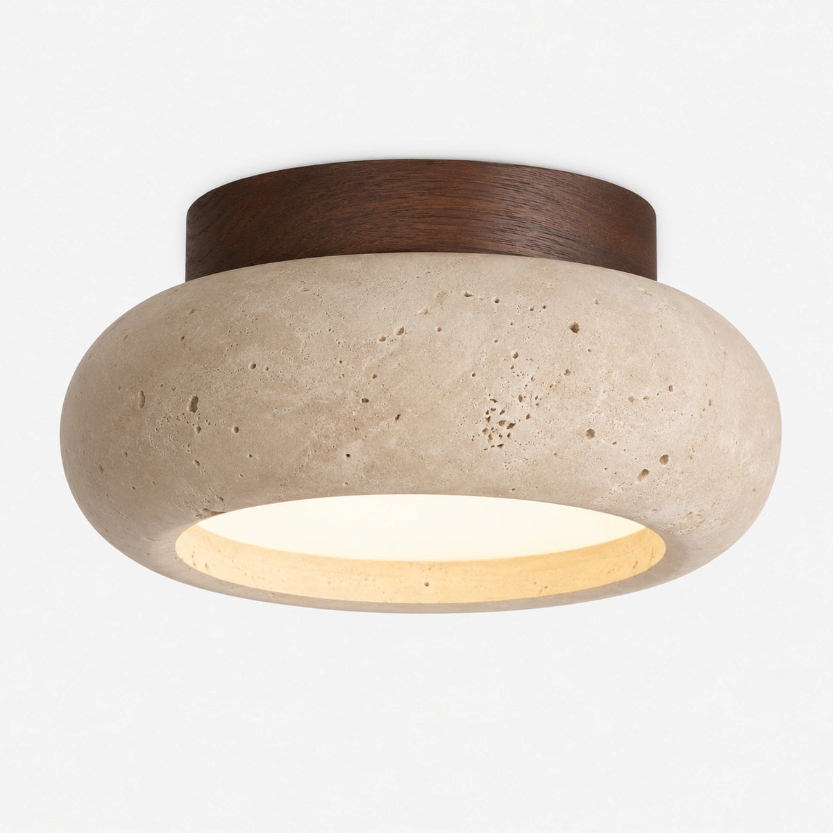 Travertine pebble flush ceiling light with a walnut collar on a white background