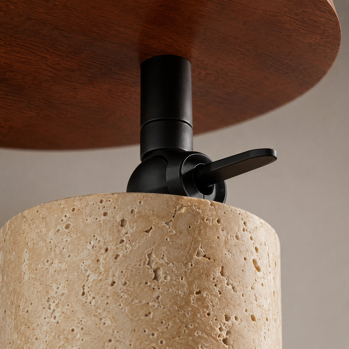 Close-up of the travertine grain on the adjustable ceiling spotlight