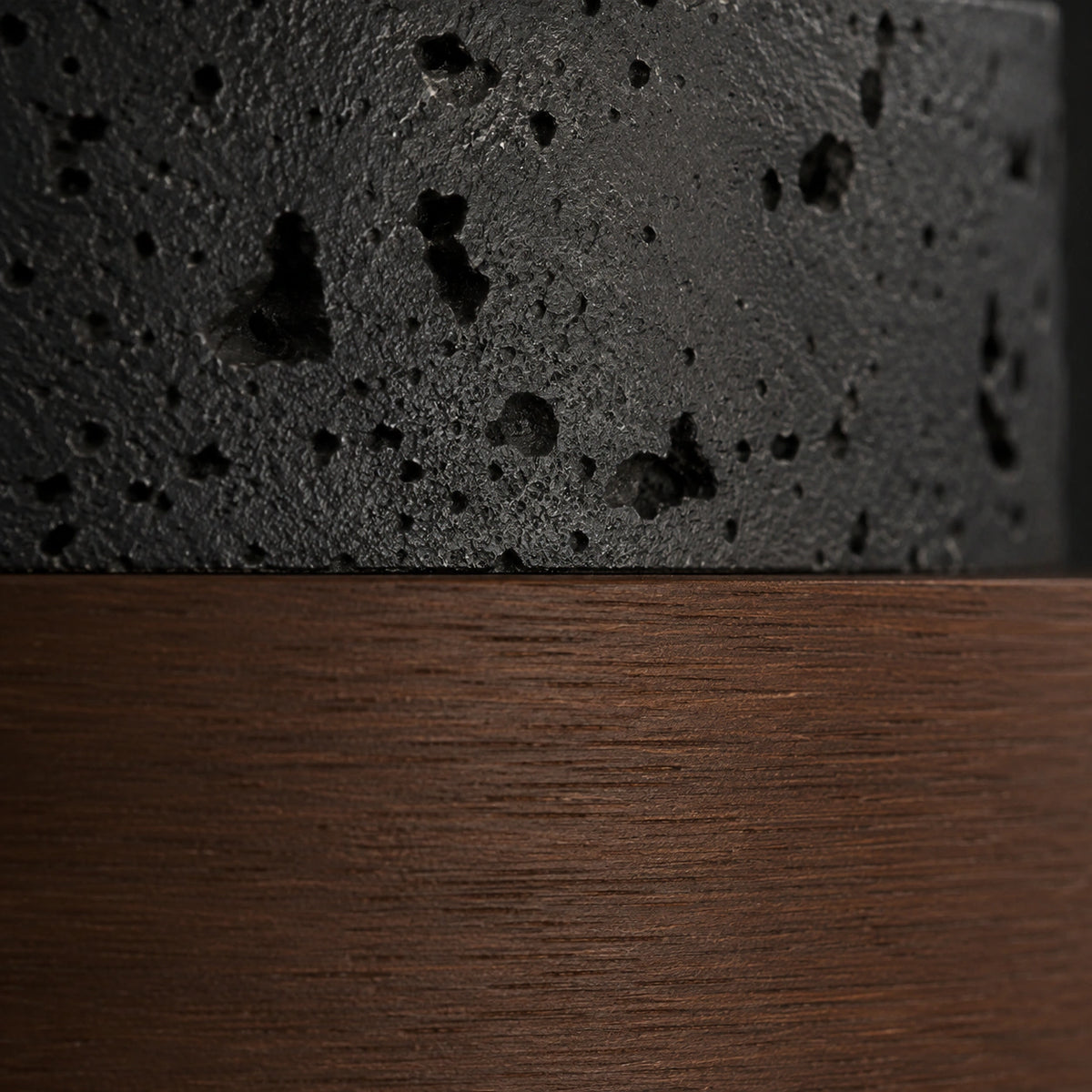 Close-up of the deep pitting in the black travertine tiered ceiling light