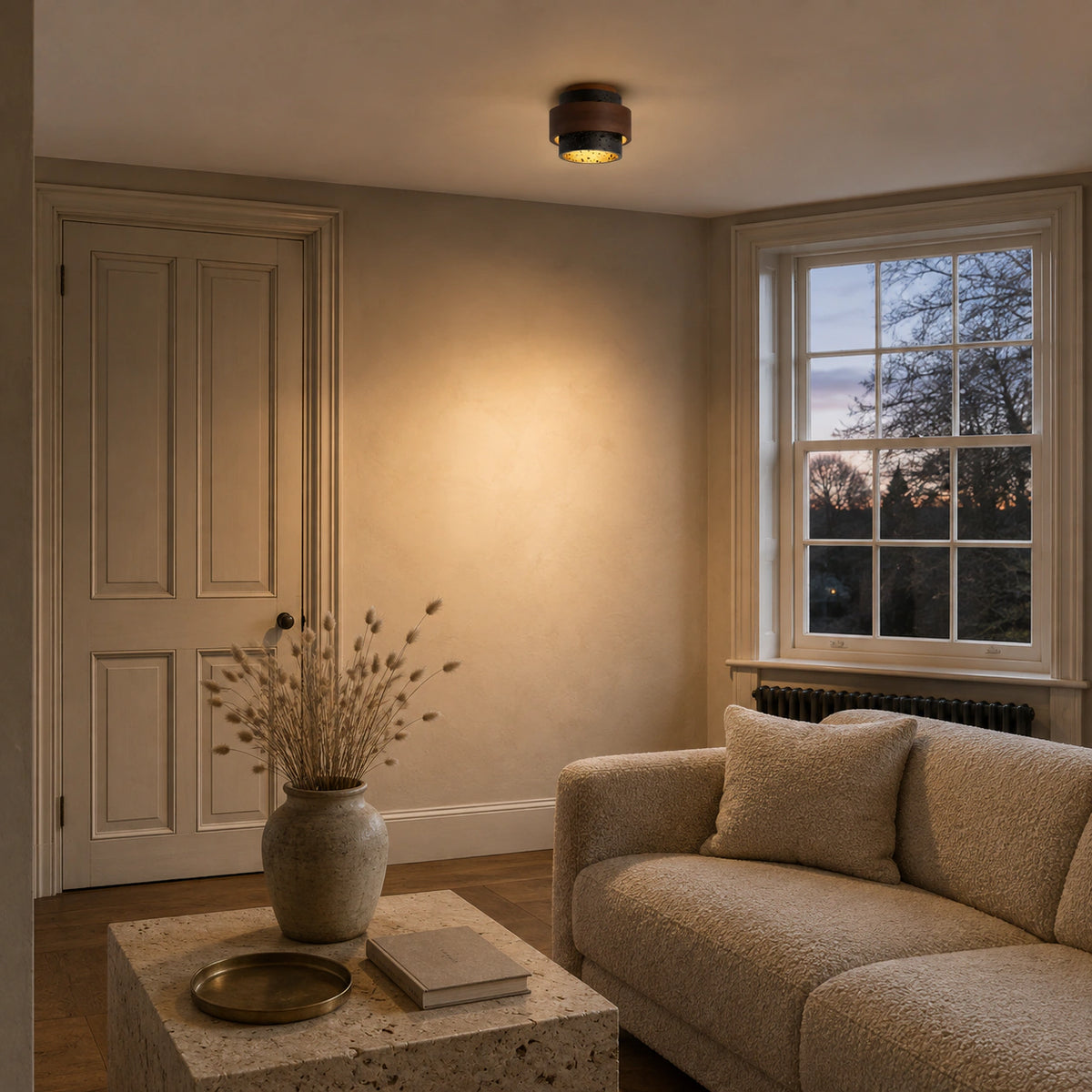 Black travertine tiered ceiling light in a calm neutral living room