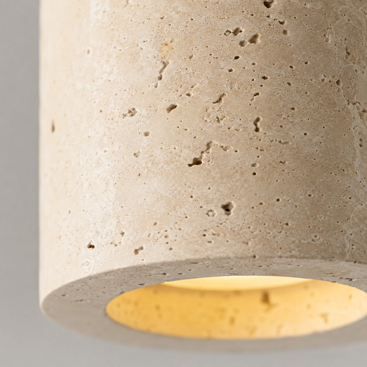 Close-up of the travertine grain on the slim tube downlight