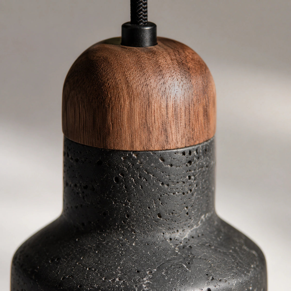 Close-up of the pale flecks in the black travertine on the Ravensworth bell pendant