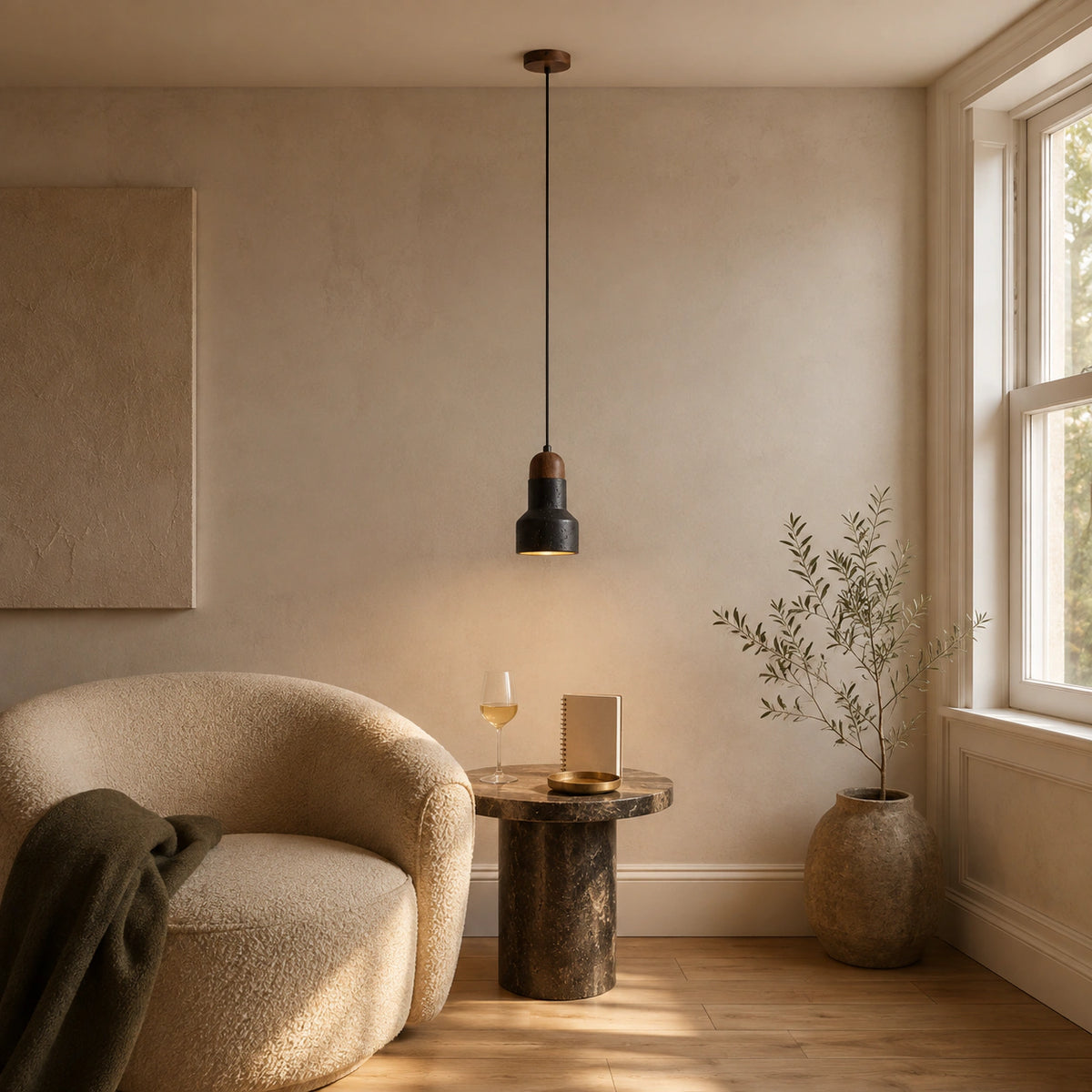 Ravensworth black travertine bell pendant in a calm living room with neutral furnishings