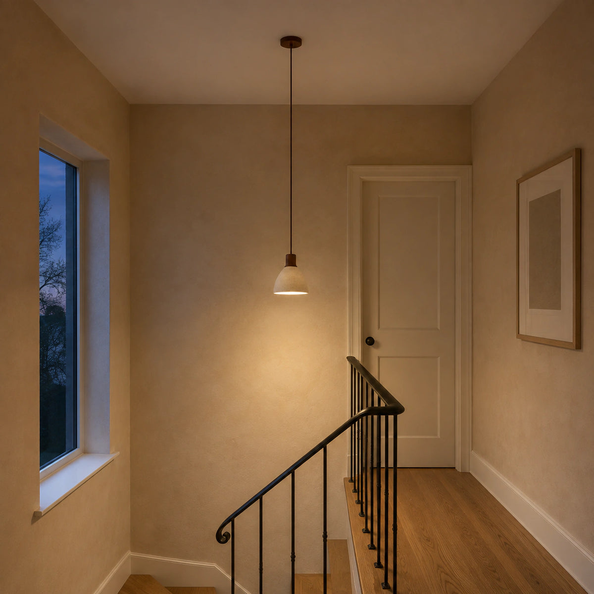 Wickham travertine bell pendant in walnut hanging above a staircase in a period property