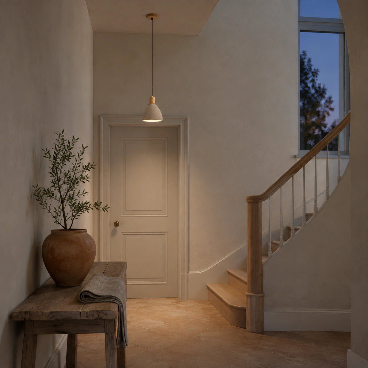 Wickham travertine bell pendant in oak hanging above a staircase landing