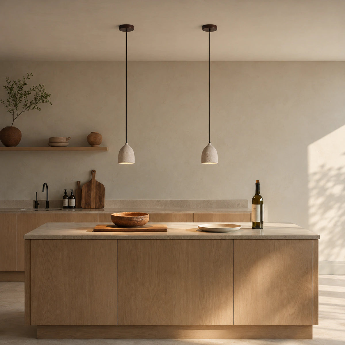 Windrush travertine bell pendant hanging above a kitchen island