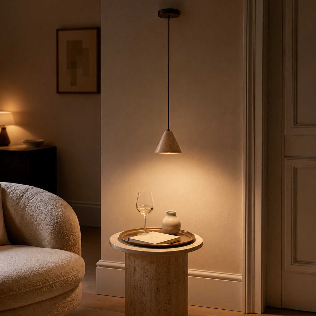 Skye cone pendant in beige travertine in a calm living room with neutral furnishings