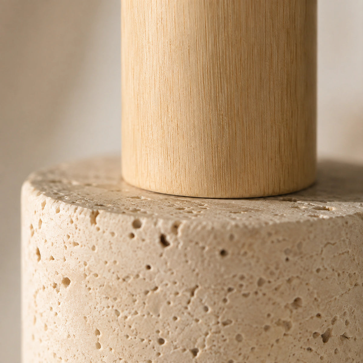 Close-up of the cream travertine grain and oak neck on the Grantley pendant
