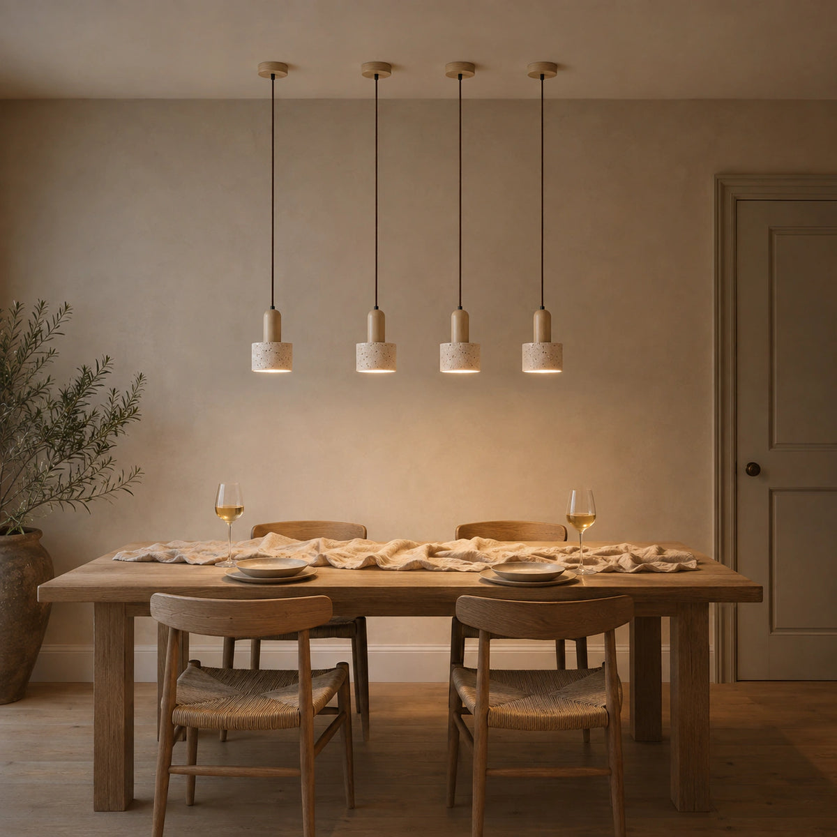 Grantley pendant in oak and cream travertine above a dining table in a minimalist room