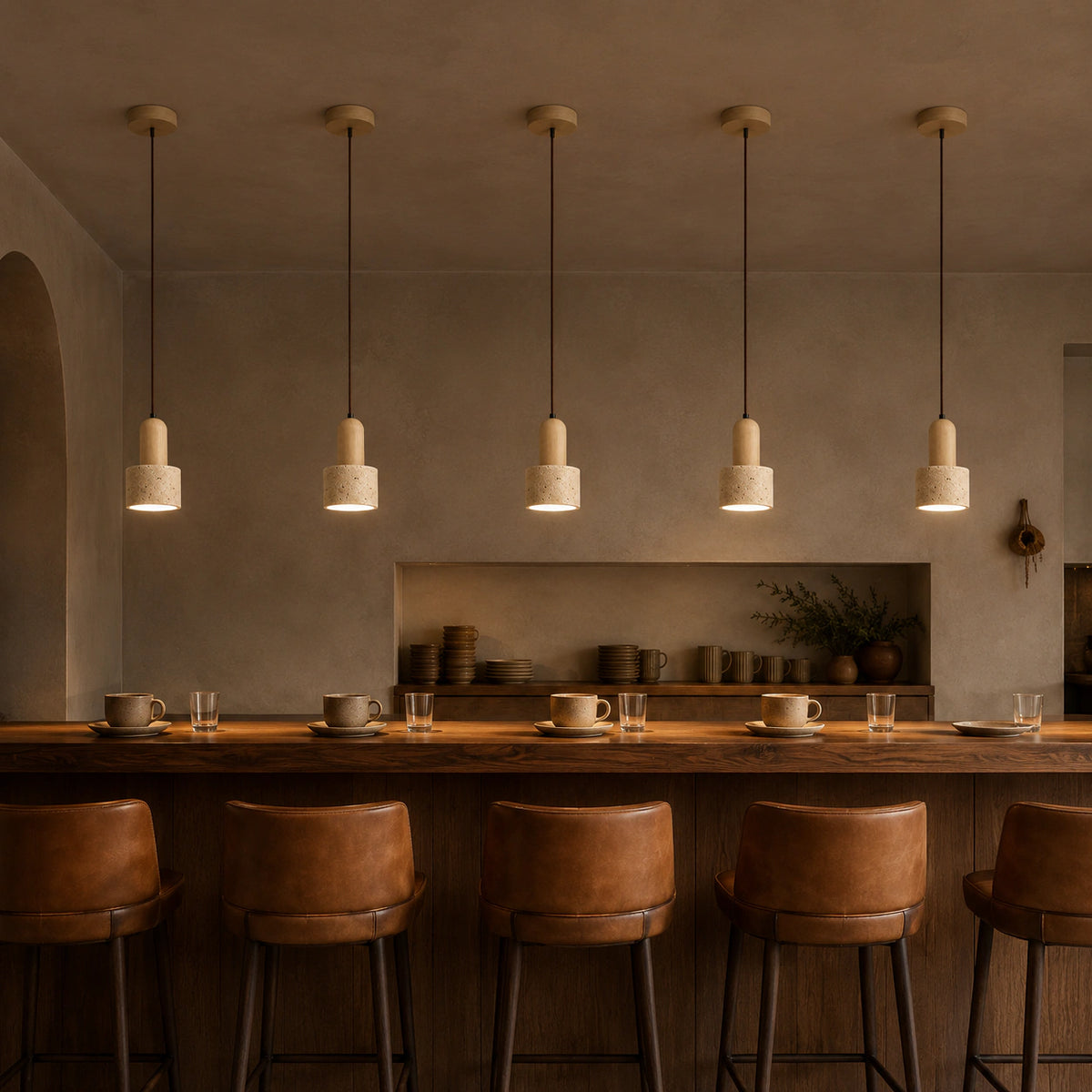 Grantley pendant in oak and cream travertine above the counter of a warm, minimalist cafe